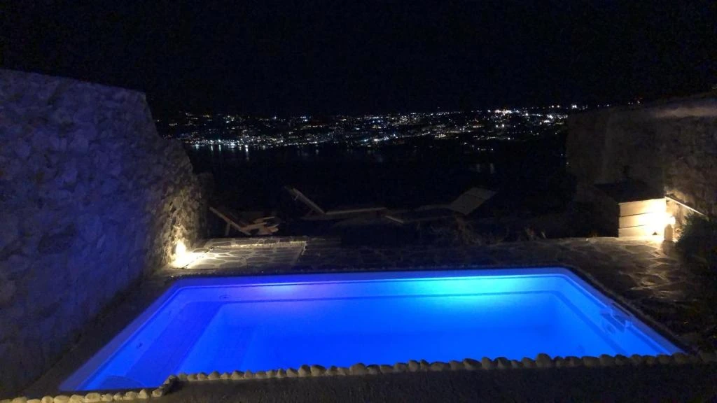 The private pool and distant island lights