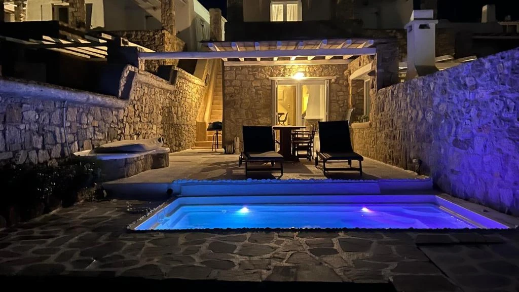 The villa and its private pool after dark